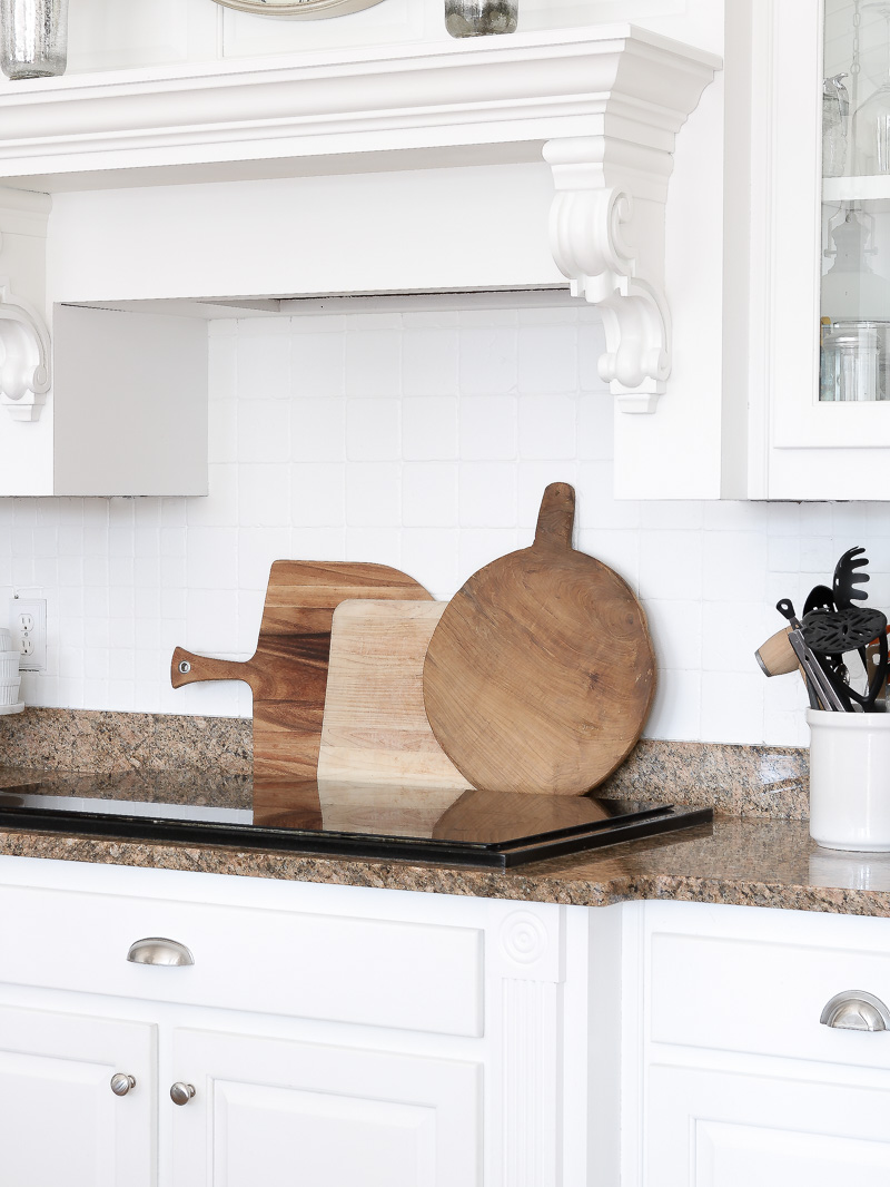 Create warmth in a white kitchen using cutting boards - Duke Manor Farm by  Laura Janning