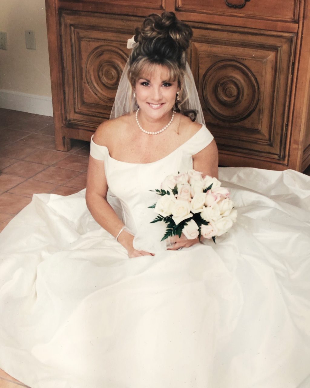 woman in white wedding dress sitting on floor