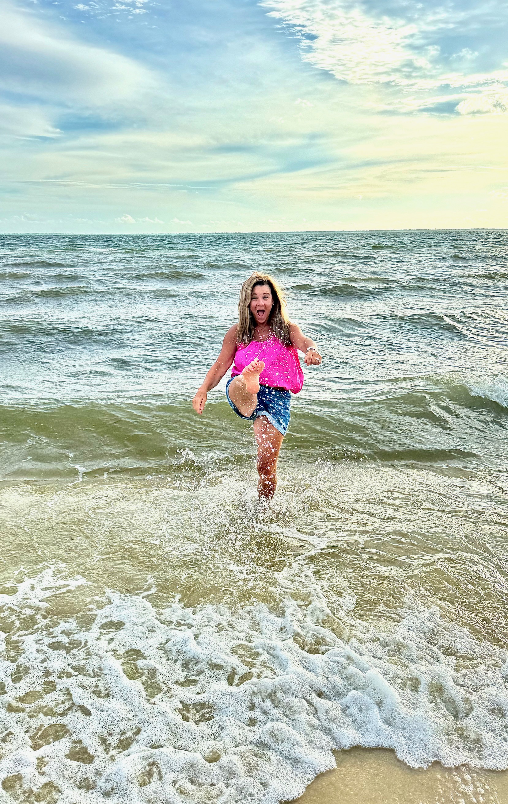 girl kicking in ocean