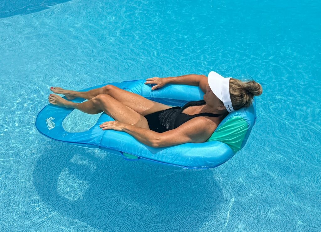 women floating in a pool using a pool ionizer