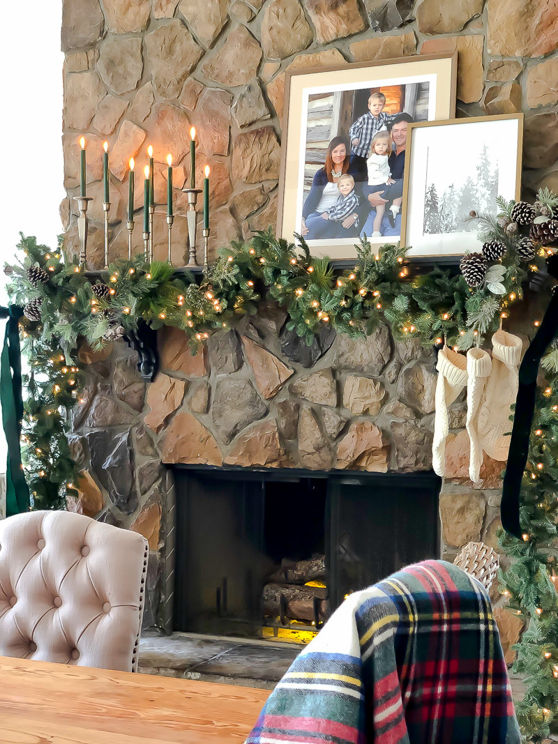 simple greenery and candles on holiday mantel