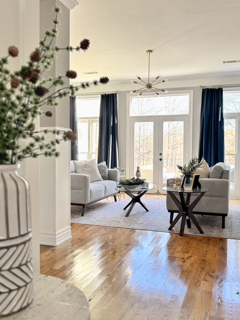 gray couches with blue curtains