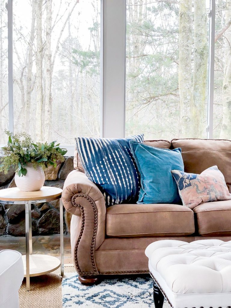 brown leather couch with spring colored accessories