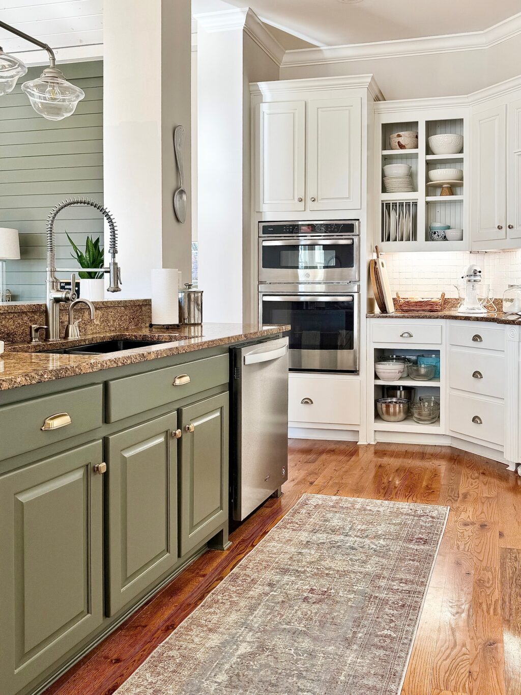 side view of kitchen island in Sherwin Williams Thunderous and  white cabinets in the background